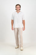 Man wearing KOIKOI mens linen trousers in natural, full-length view